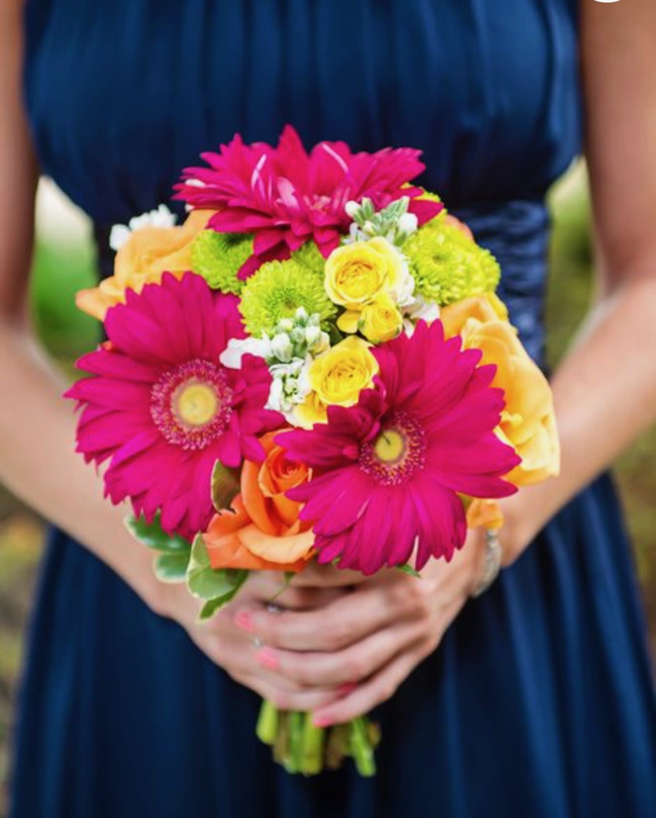 Bouquet of pink gerbera daisies, yellow roses, and orange roses