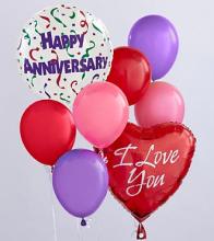 Anniversary balloons in red, pink, and purple with two printed message balloons