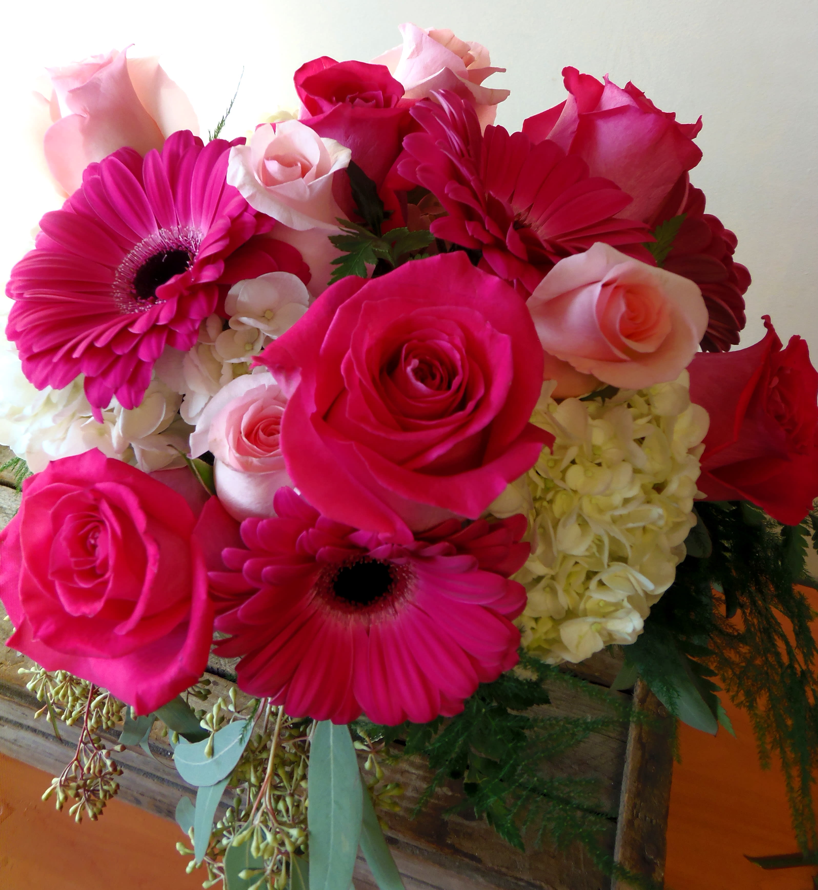 Amore 16v1 - Amore Lush Floral Vase Bold, romantic, and full of charm—“Amore” is a lush mix of breathtaking blooms. Featuring vibrant hot pink roses, delicate light pink roses, striking hot pink gerbera daisies, and elegant hydrangea, all artfully arranged in a clear glass vase. This stunning arrangement is perfect for expressing love, admiration, or simply making someone feel truly special.