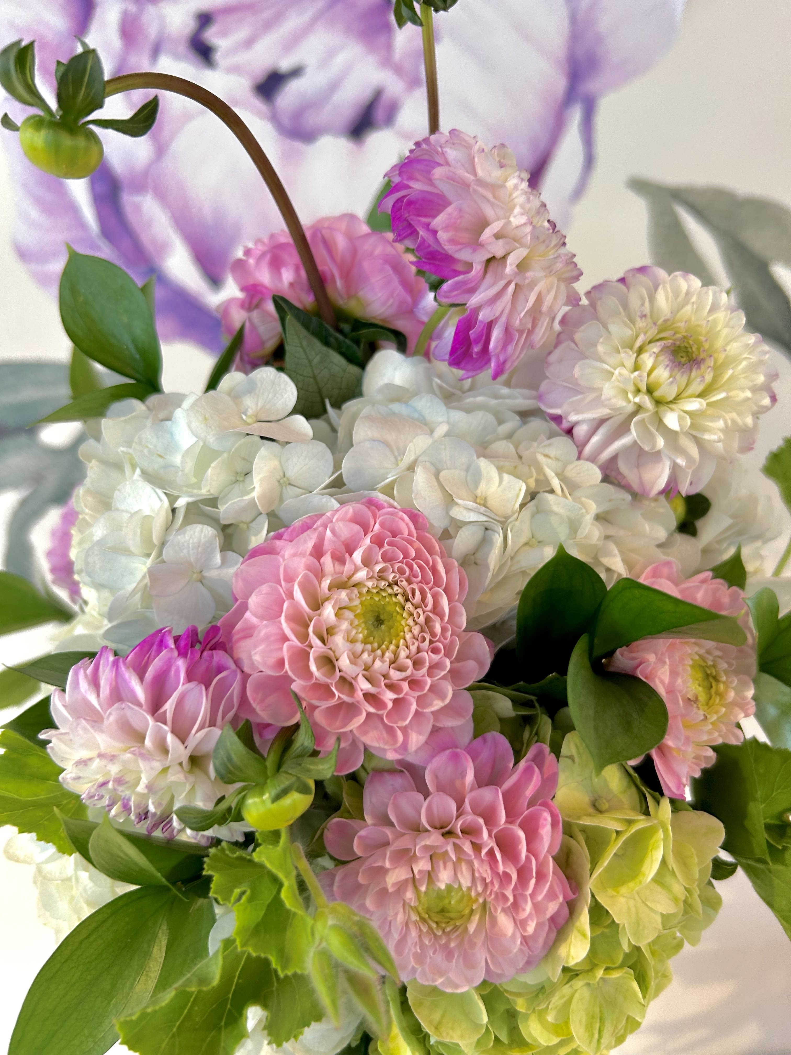 Pink and white flowers arranged with green foliage