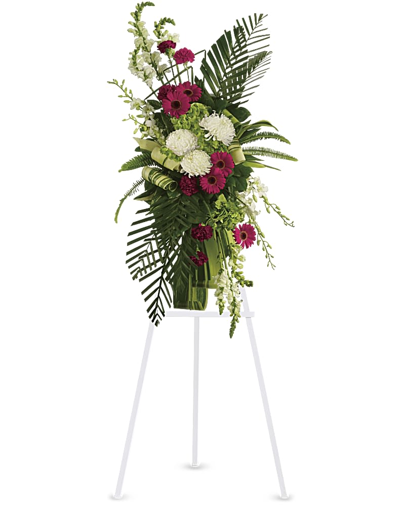 Tall floral standing spray with pink and white blooms on an easel