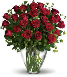 Red roses arranged in a clear glass vase