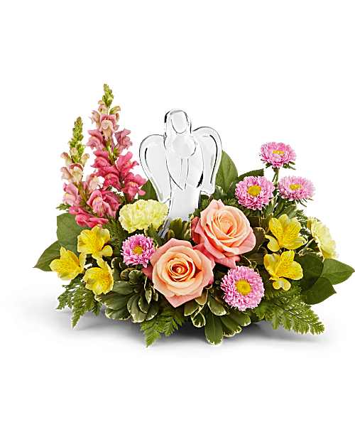 Angel's Embrace Bouquet  - Radiating peace and comfort, Angel's Embrace Bouquet surrounds a sparkling crystal angel keepsake with peach roses, pink blooms, and sunny yellow flowers-a graceful way to honor love's eternal light. The Angel's Embrace Bouquet features peach roses, yellow alstroemeria, yellow carnations, hot pink snapdragons, and pink matsumoto asters, complemented by leatherleaf fern, variegated pittosporum, and lemon leaf. Presented with a crystal angel keepsake. Considered a small to medium arrangement.
