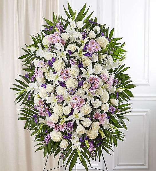 Lavender Tears - When words alone cannot convey the feelings in your heart, flowers can provide a meaningful and profound statement. Our impressive standing spray arrangement is meticulously handcrafted by expert local florists with soothing lavender and white blooms for a lush, full presentation, presenting an elegant and memorable tribute.