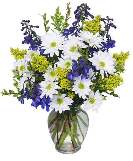 Bouquet of white daisies and blue flowers in a glass vase