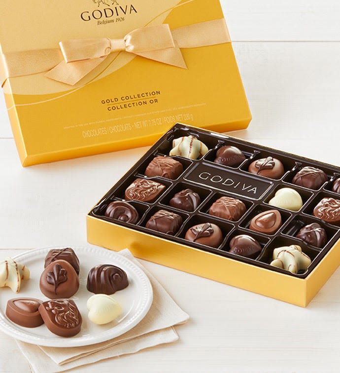 Box of assorted chocolates with a yellow gift box and ribbon
