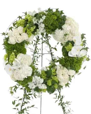 White and green floral wreath on a stand