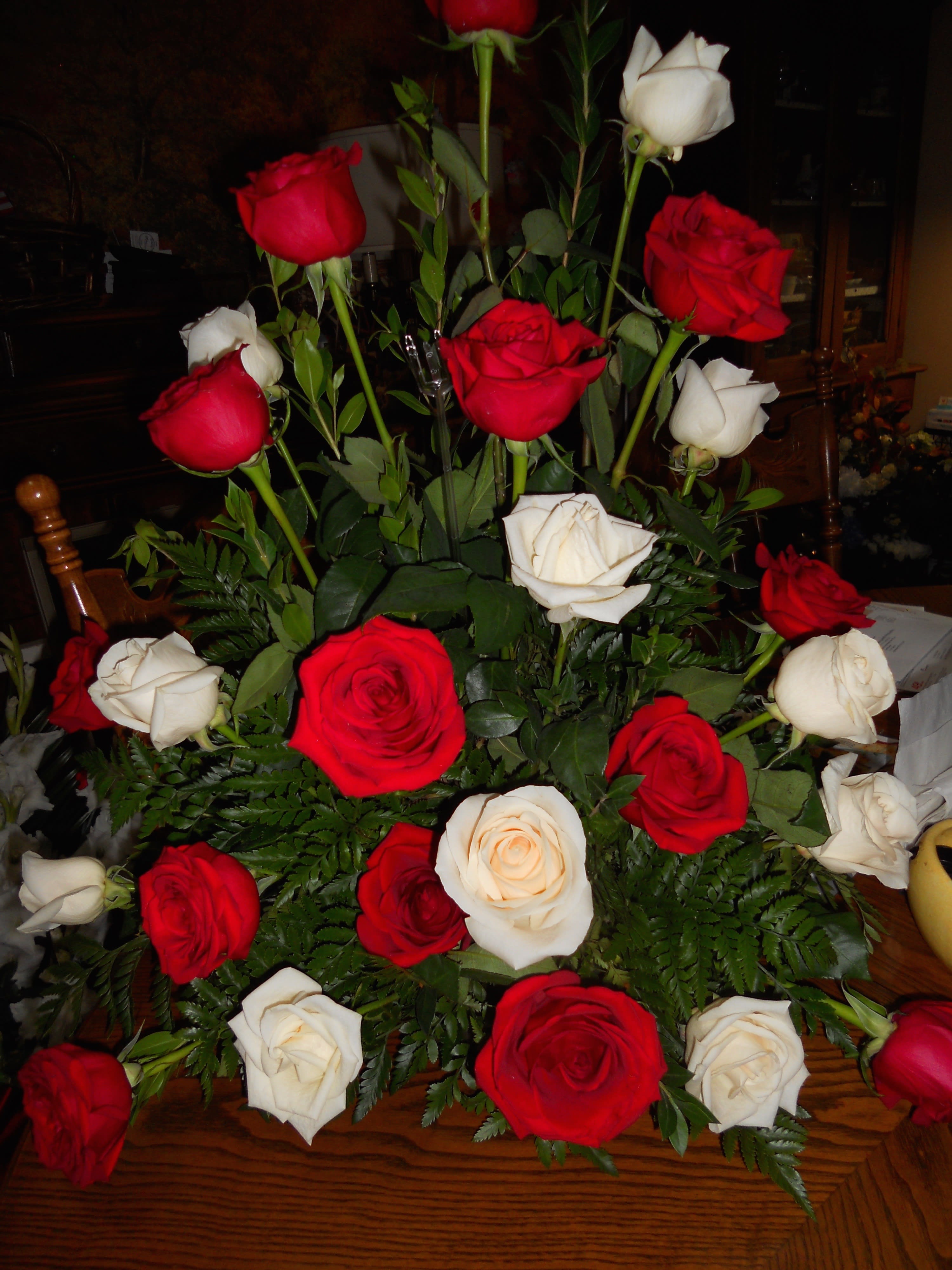 Bouquet of red and white roses with fern foliage