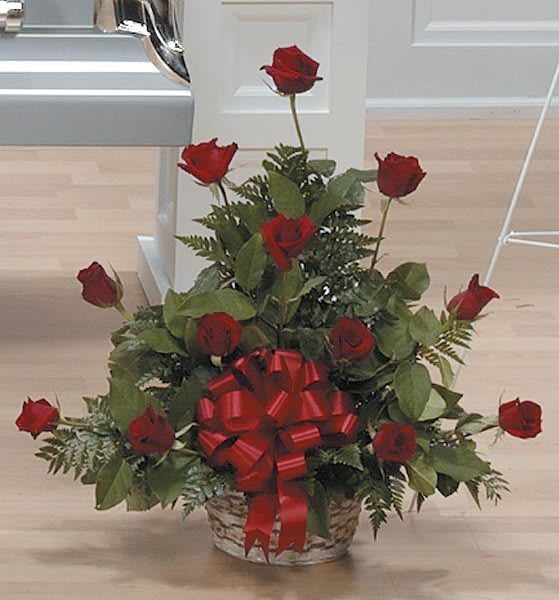Basket arrangement of red roses with a large red bow