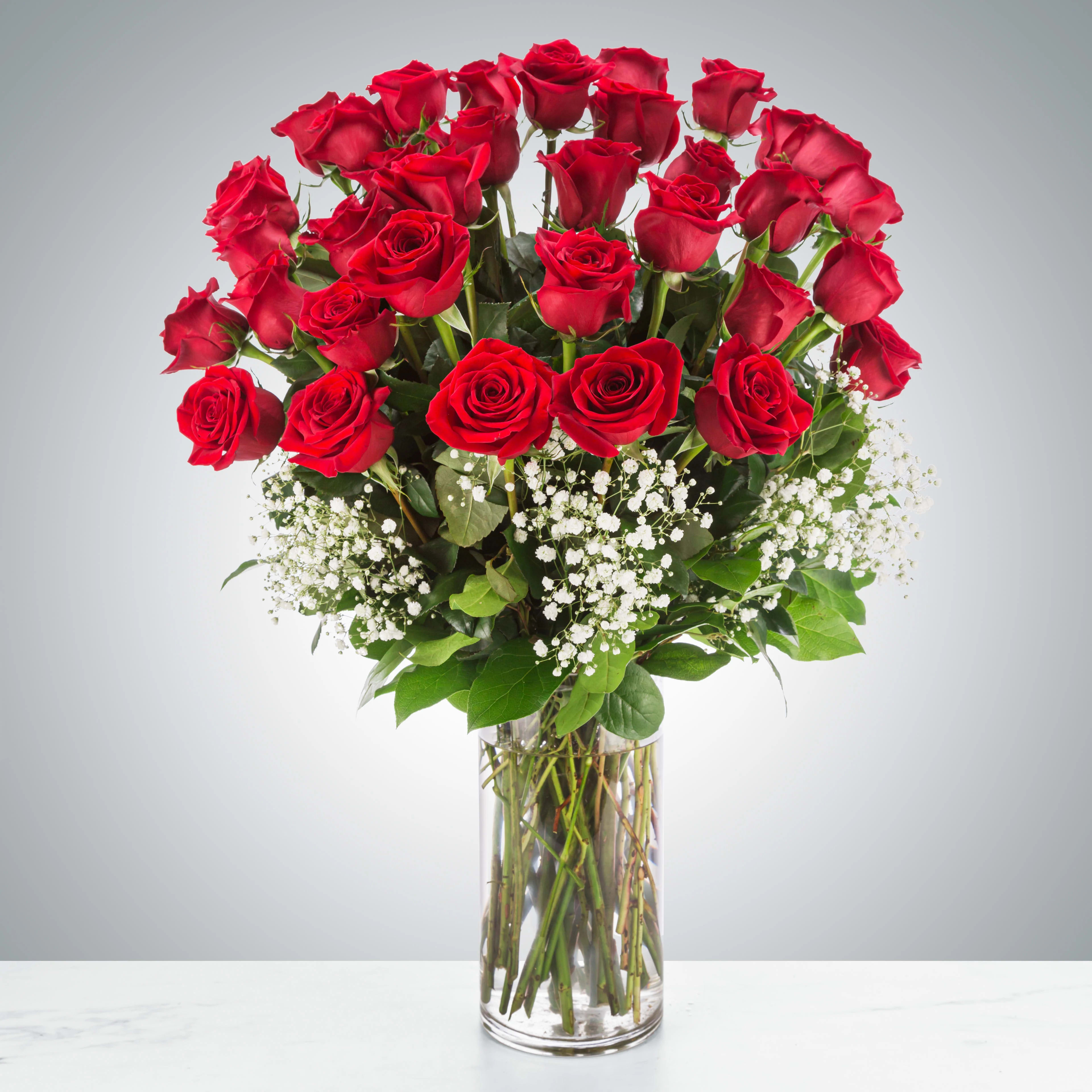 Grandeur Long Stem Rose Arrangement by BloomNation™ - Go big with your love. Send the most extravagant 3 dozen red rose arrangement for Valentine's day, anniversary celebrations, or declarations of love. This luxury arrangement makes a big statement of "I love you" in 36 roses.  Approximate Dimensions: 20"D x 32"H