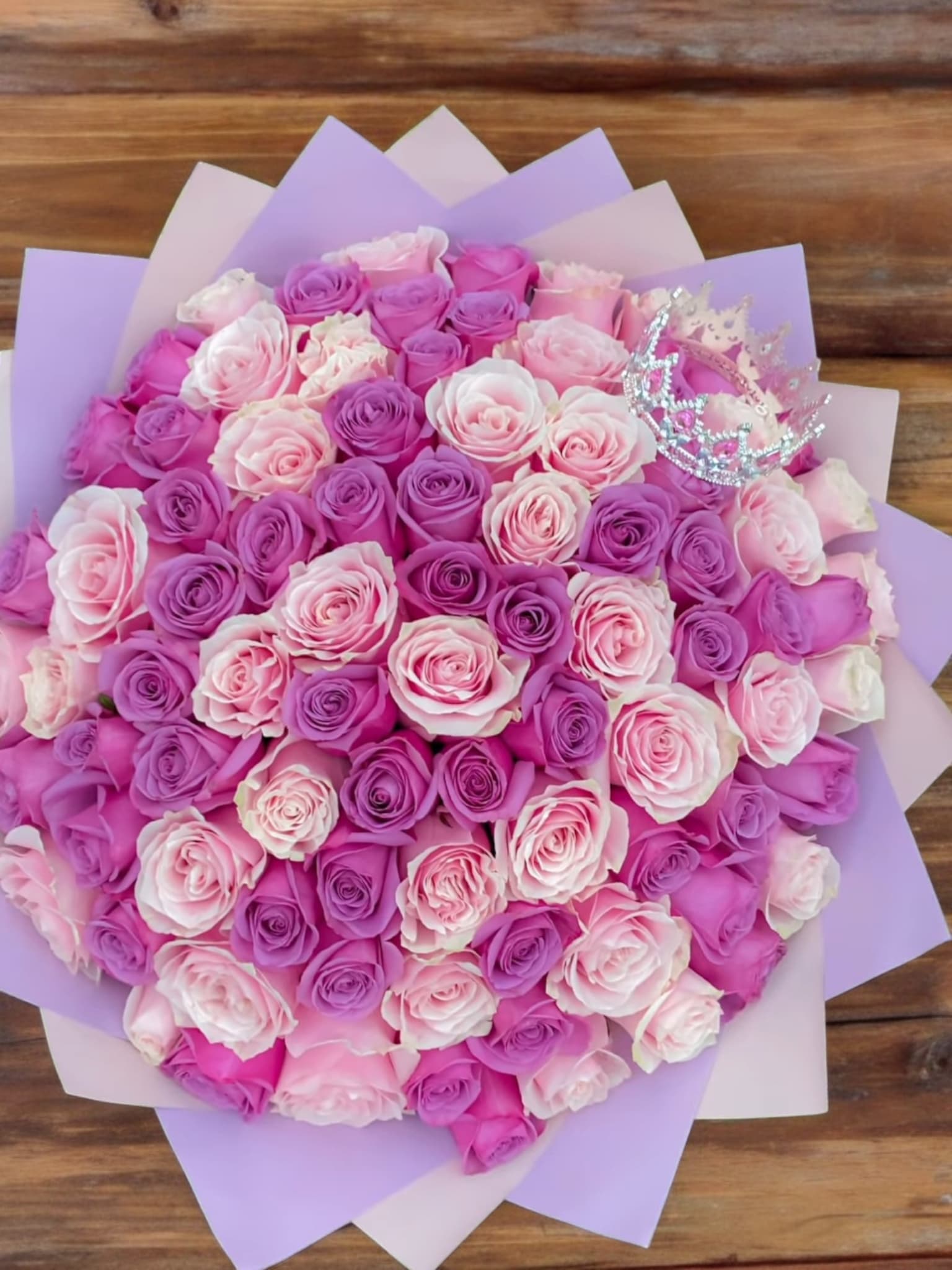 Bouquet of pink and lavender roses with a small jeweled crown