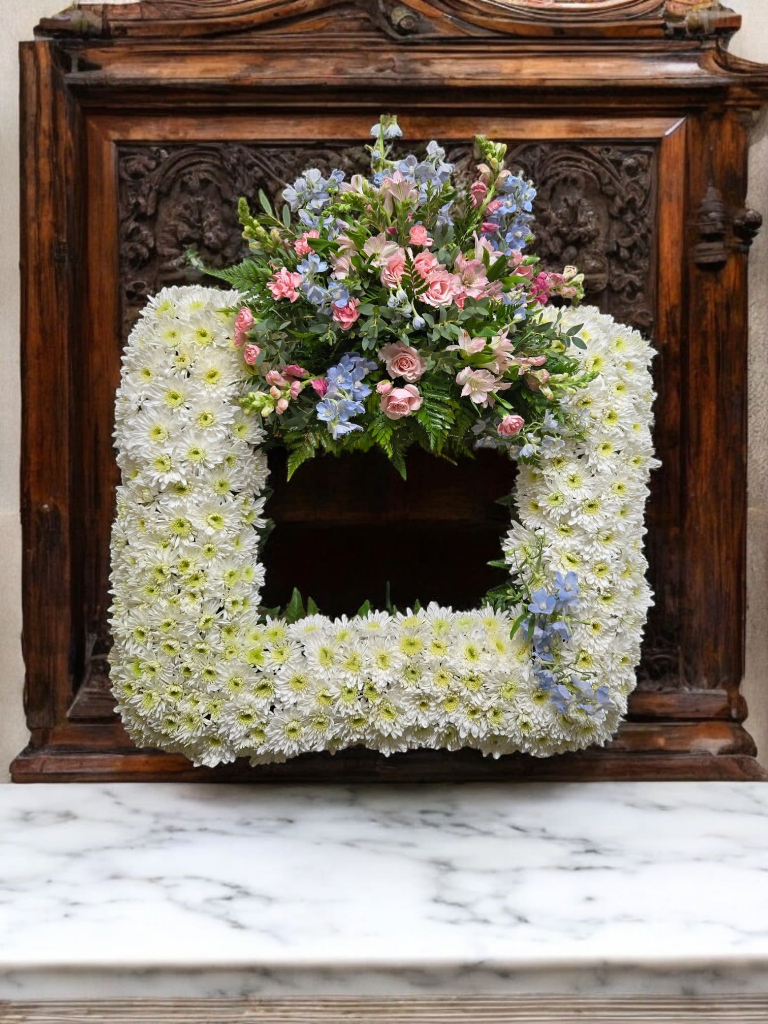 Square floral wreath with white daisies and pastel pink and blue flowers