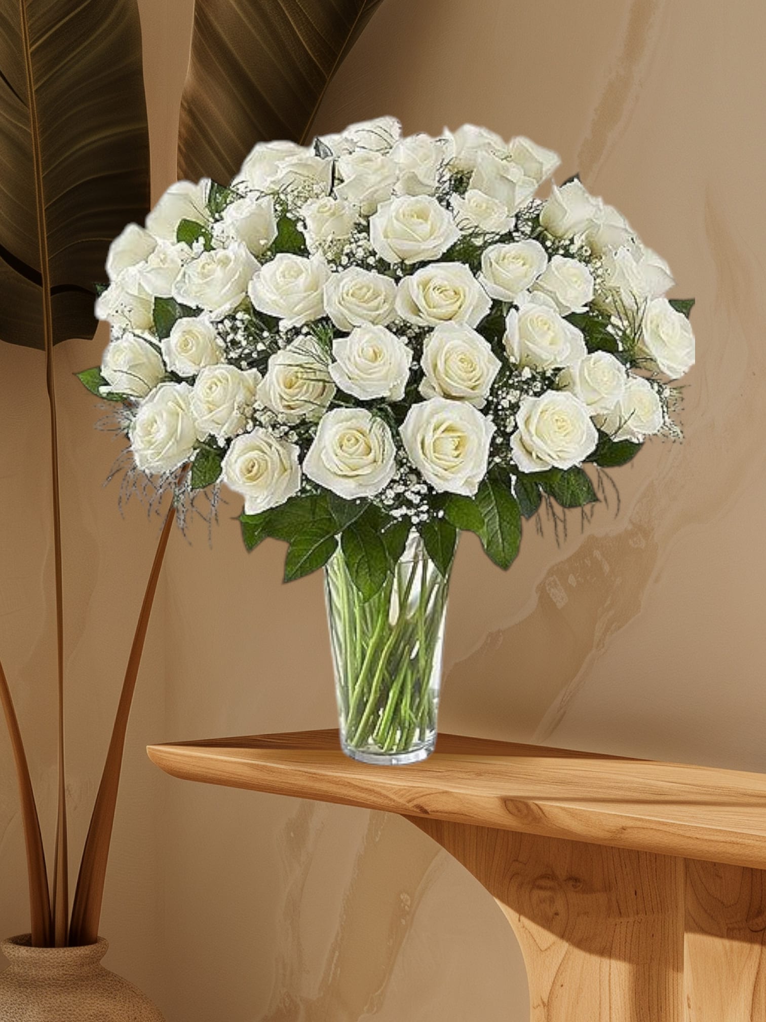 Bouquet of white roses in a clear glass vase