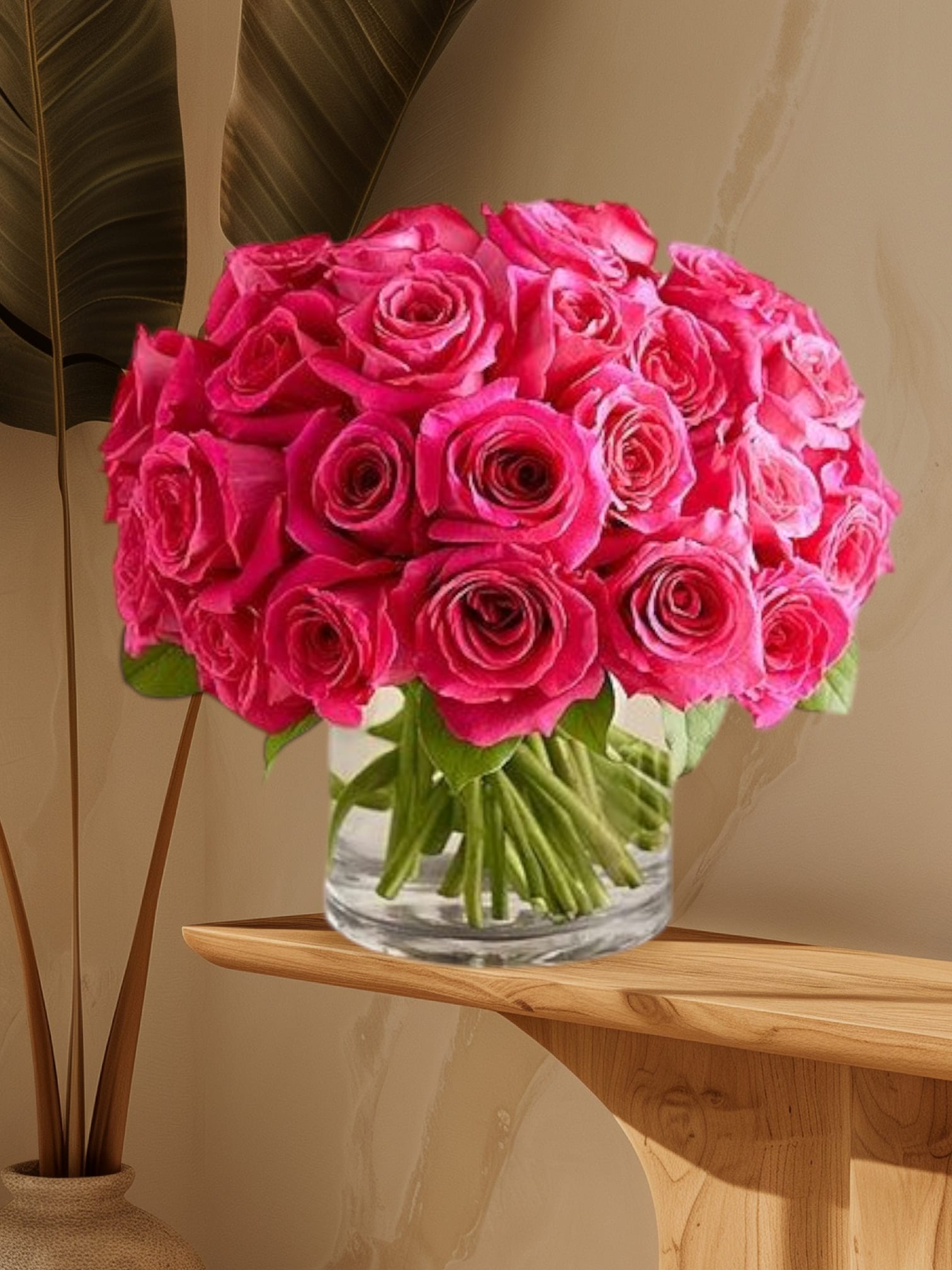 Bouquet of bright pink roses in a clear glass vase