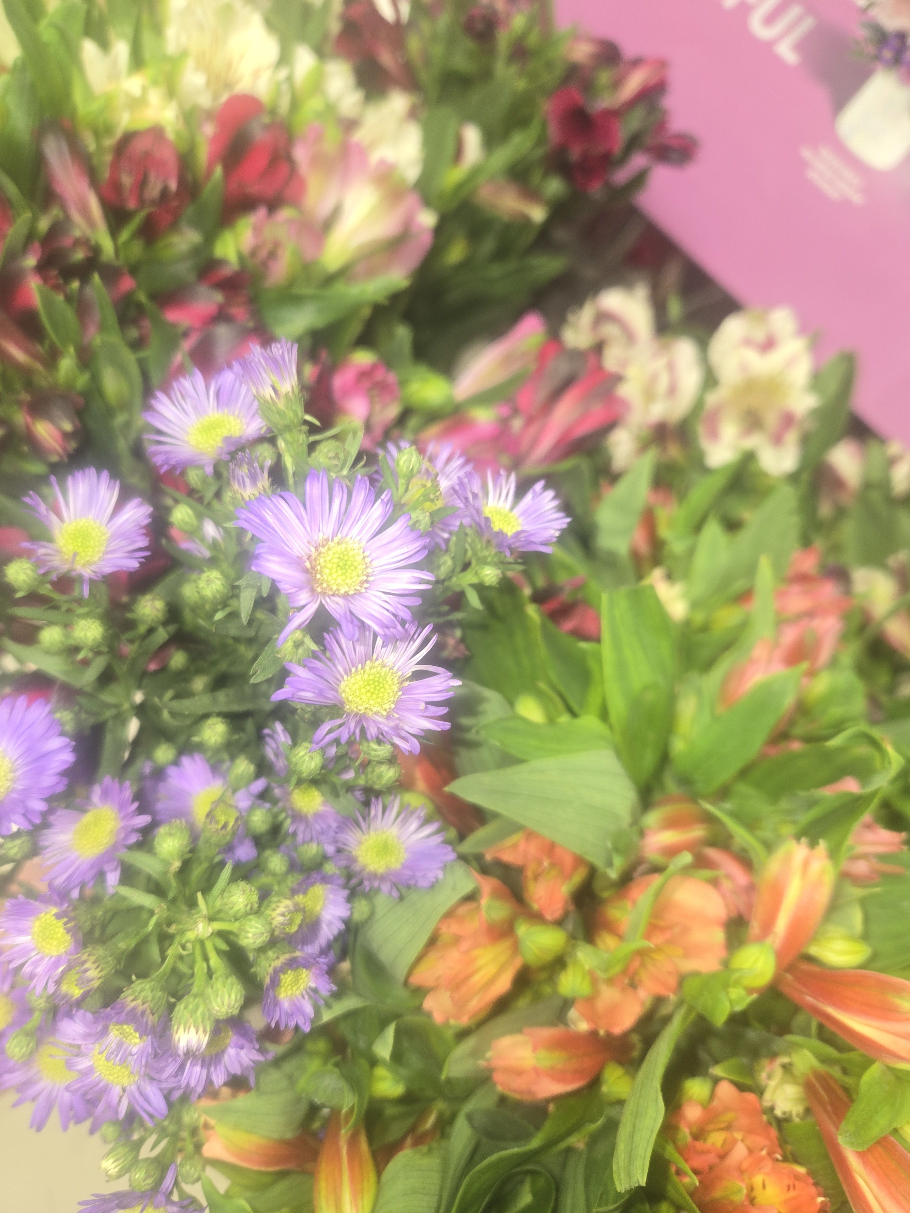 Bouquets of purple daisies and orange alstroemeria flowers