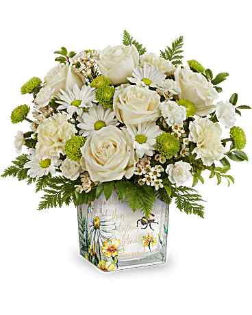 White roses and daisies in a decorated glass vase