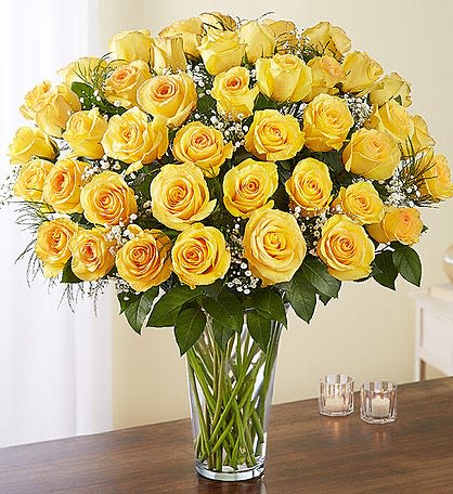 Yellow roses arranged in a clear glass vase