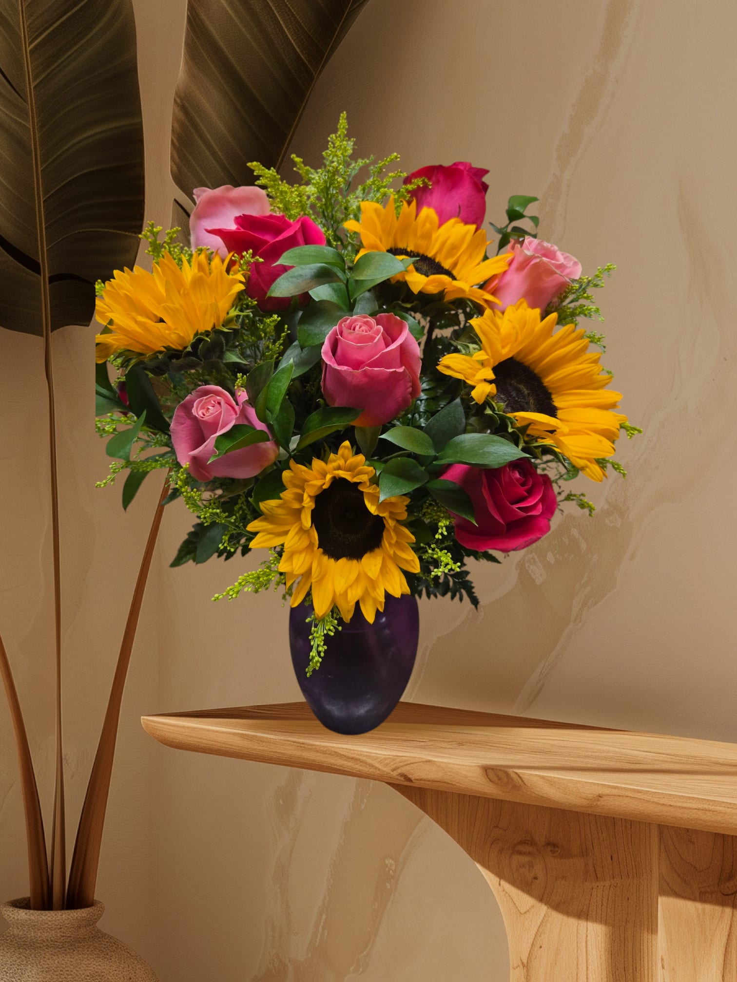 Bouquet of pink roses and sunflowers in a dark vase