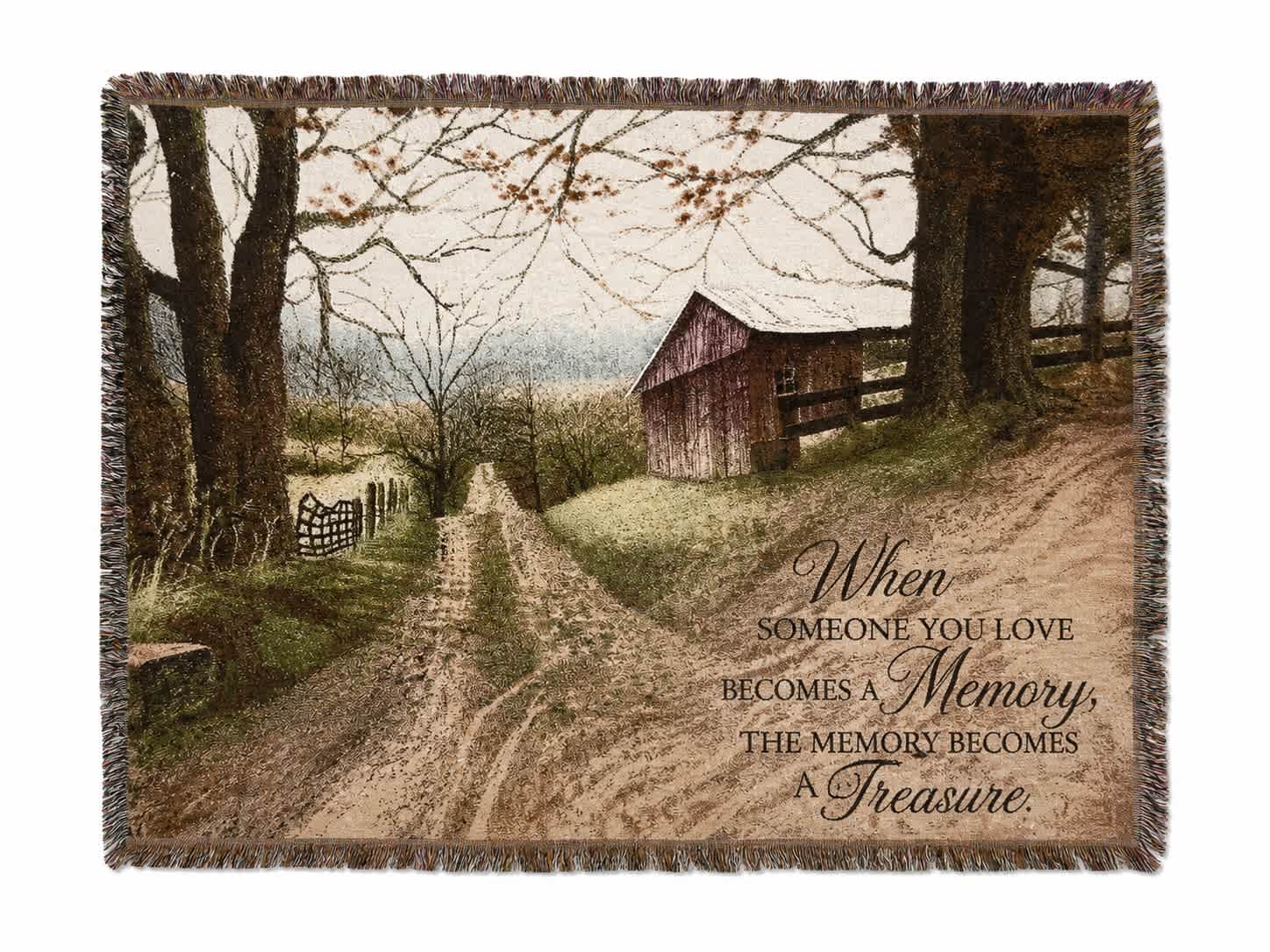 Fringed throw blanket with a rustic barn scene and memorial quote