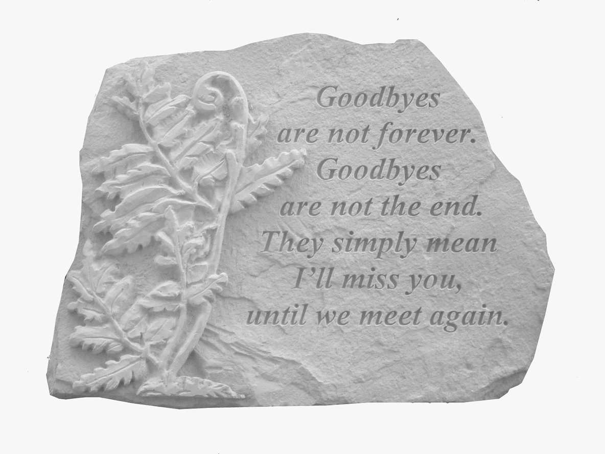 Stone memorial plaque with an engraved leaf and farewell quote