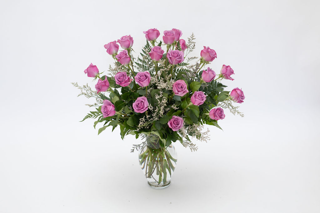 Pink roses arranged in a clear glass vase