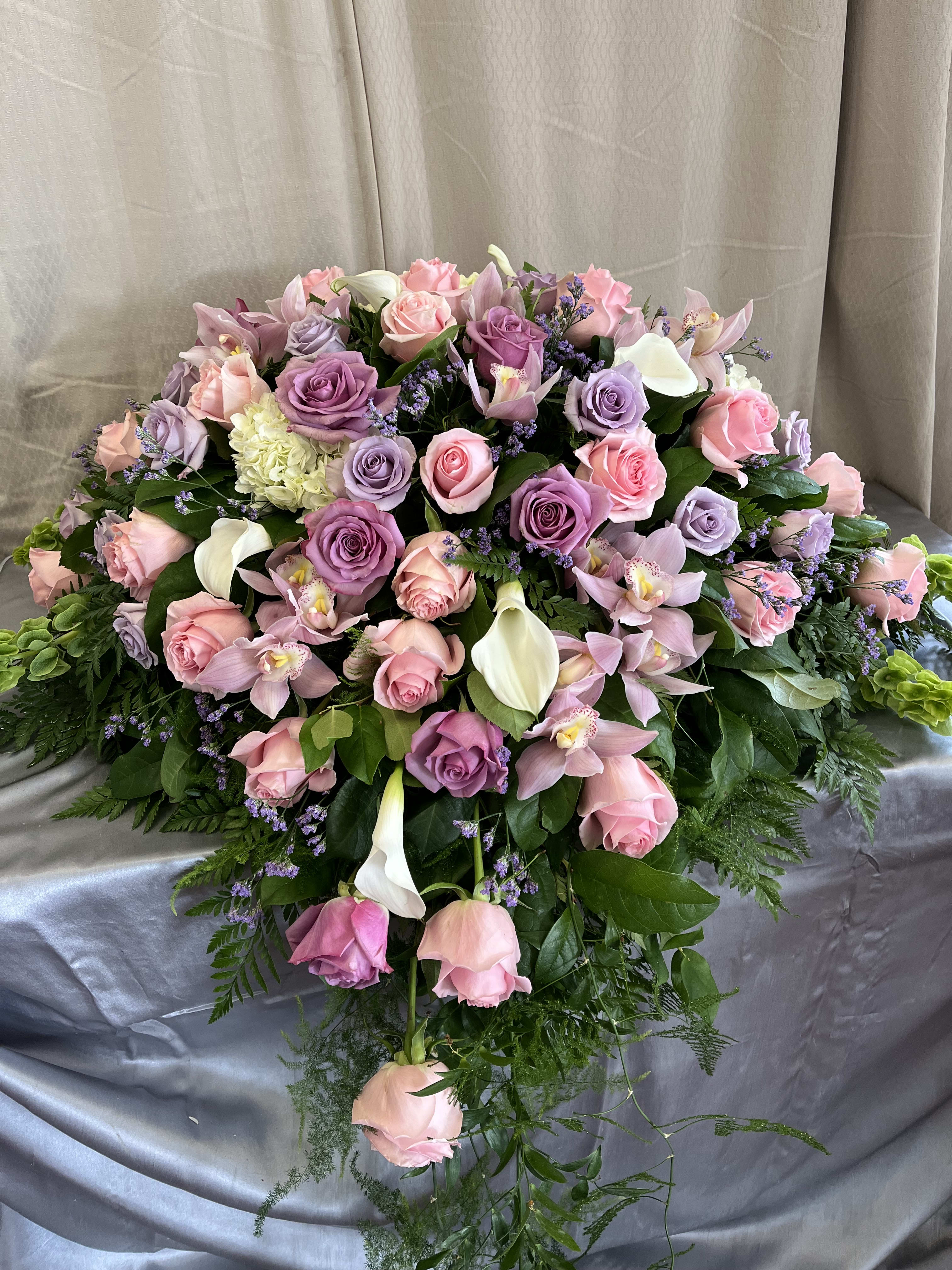 Large bouquet of pink and lavender roses with orchids and white calla lilies
