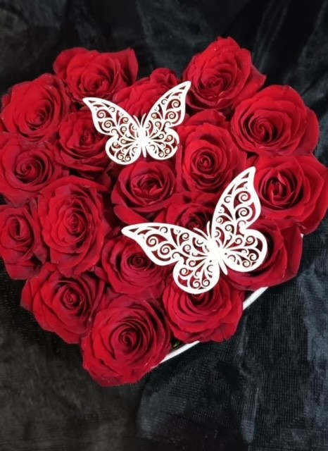 Heart-shaped bouquet of red roses with white butterfly decorations