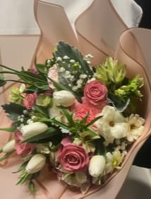 Bouquet of pink and white flowers wrapped in blush paper