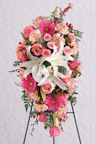 Pink and white floral standing spray with lilies, roses, and gerbera daisies