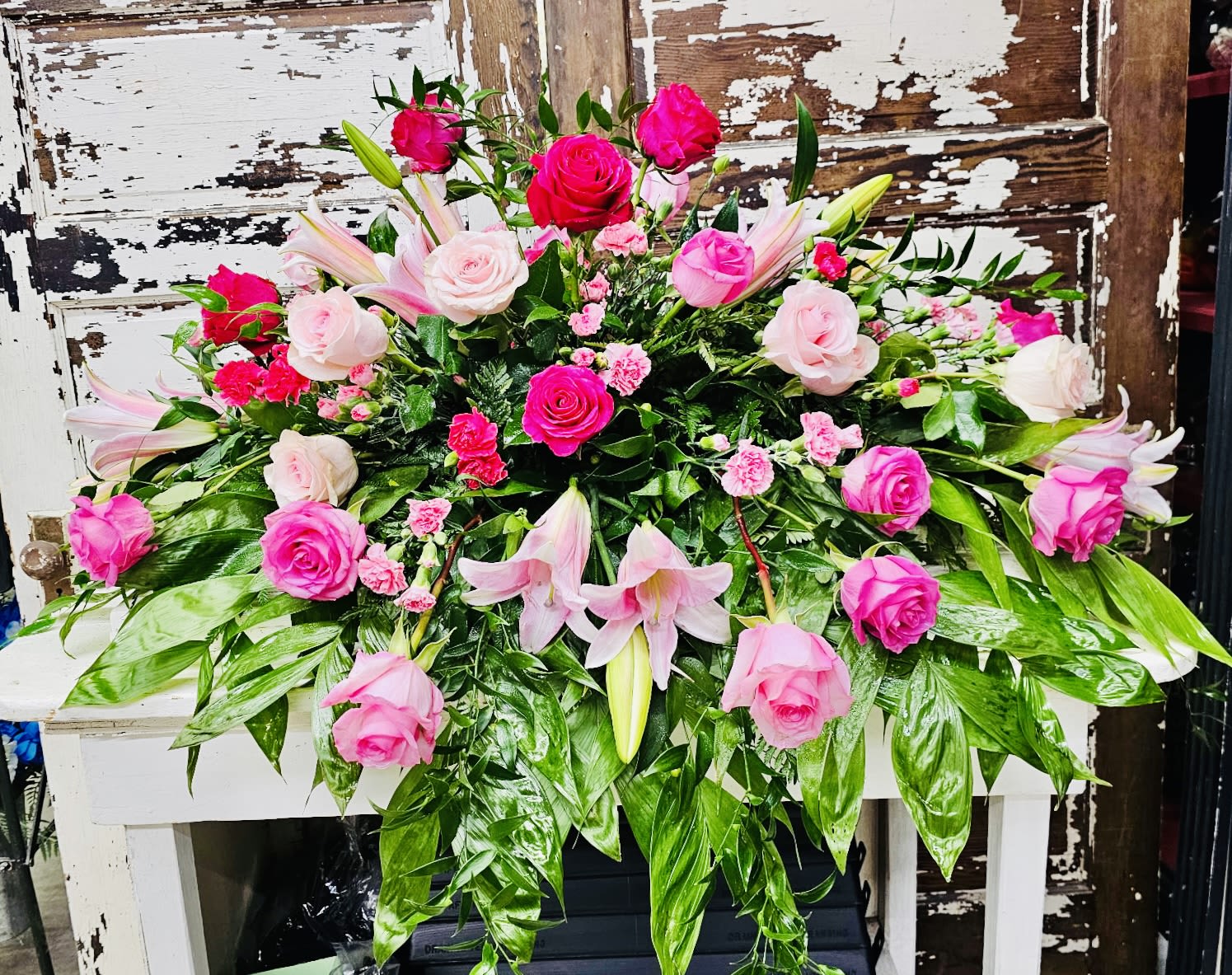 Pink roses and lilies arranged in a large floral display