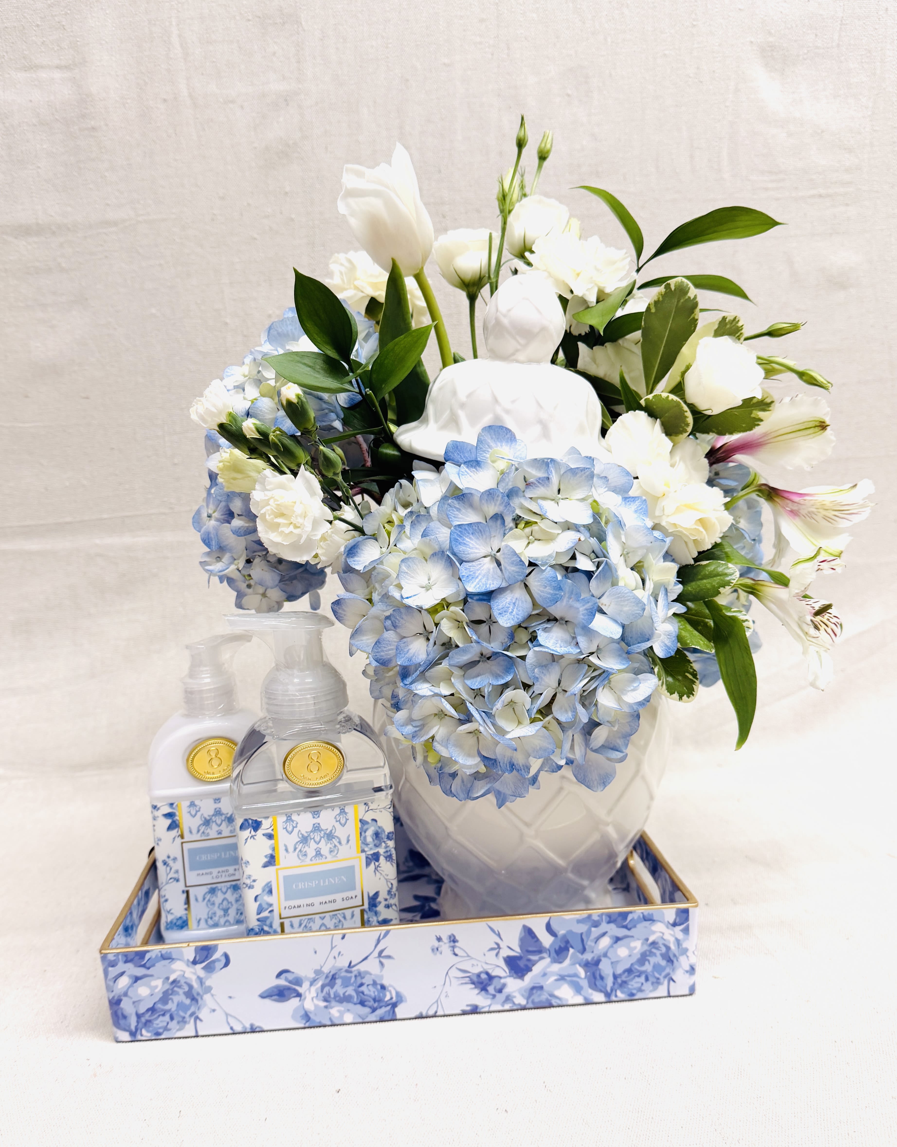 Blooms and Such - These beautiful blooms are contained by a stunning lidded ginger jar!!!  The wonderful "Crisp Linen" scented Foaming Hand Soap and Hand and Body Lotion just tops off the perfect gift!!!  The tray keeps it all neat and tidy making this a special treat for that special someone in your life!!!