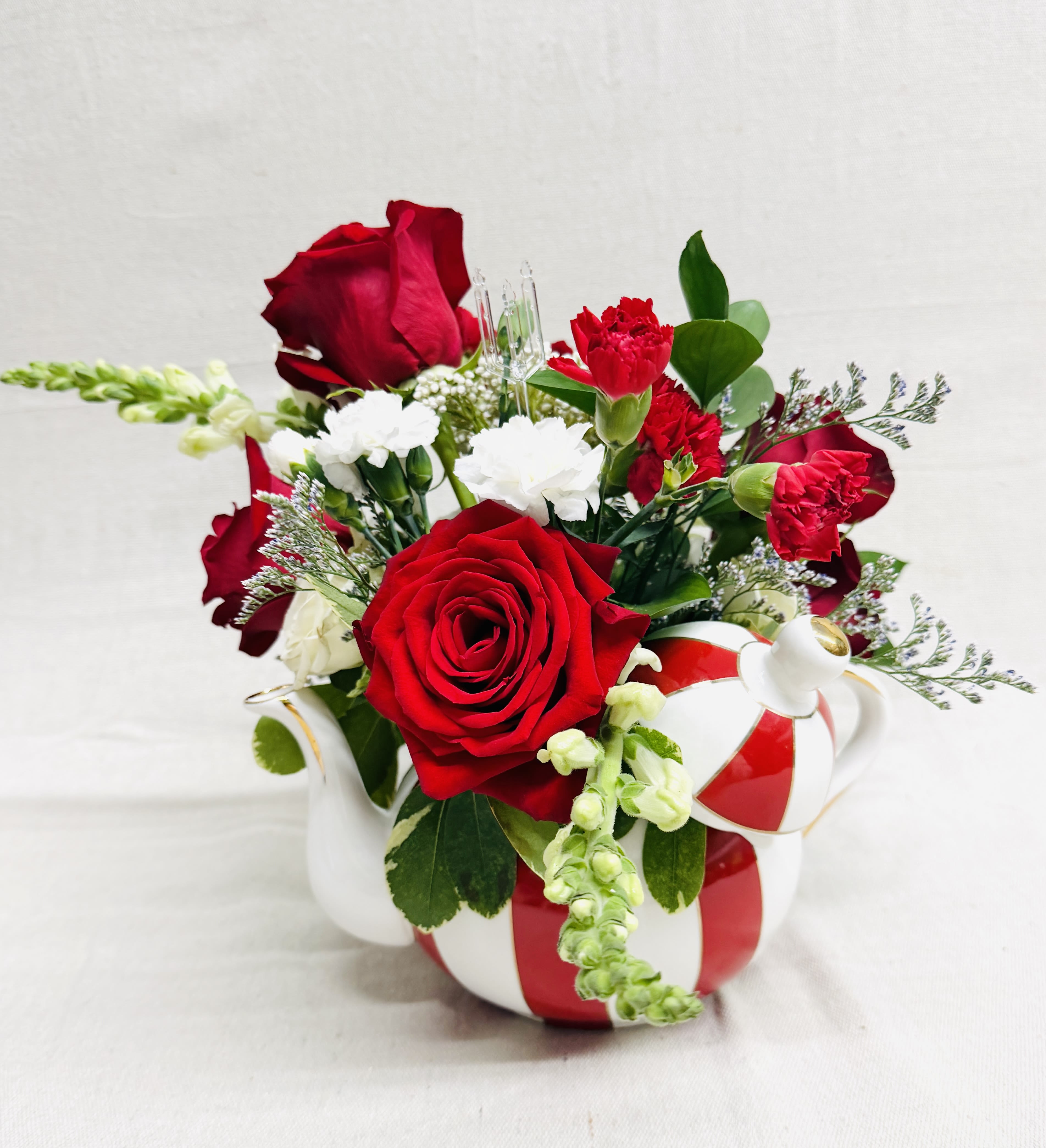 The Teapot - This red and white teapot is stunning when filled with beautiful flowers.  When the blooms fade, this teapot will be beautiful in your kitchen for years to come!