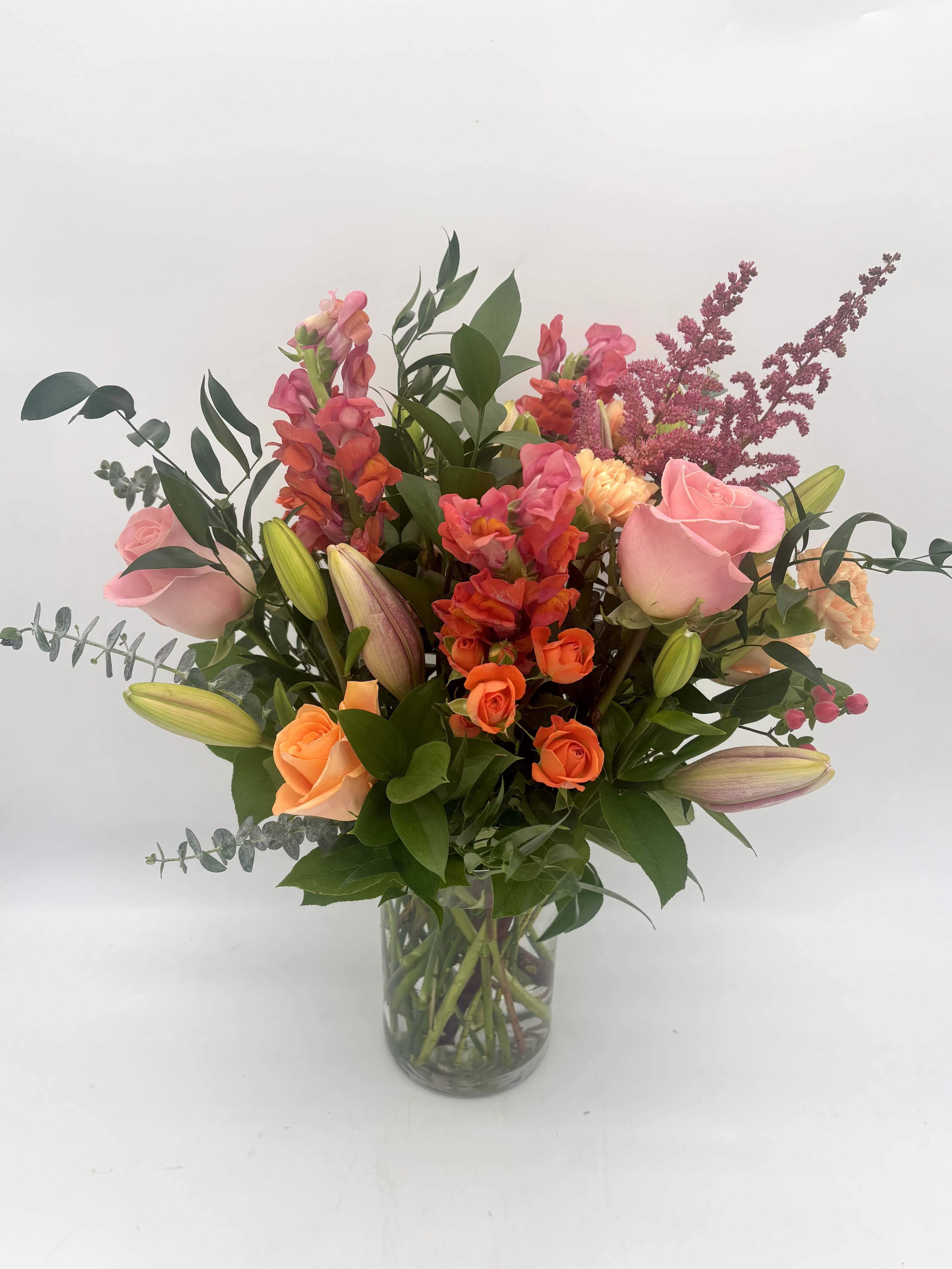 Sun-Kissed Horizon - Sun-Kissed Horizon brings the warmth of a beautiful sunset indoors featuring a range of pinks and oranges. This cheerful arrangement is perfect for brightening someone's day no matter the occasion!