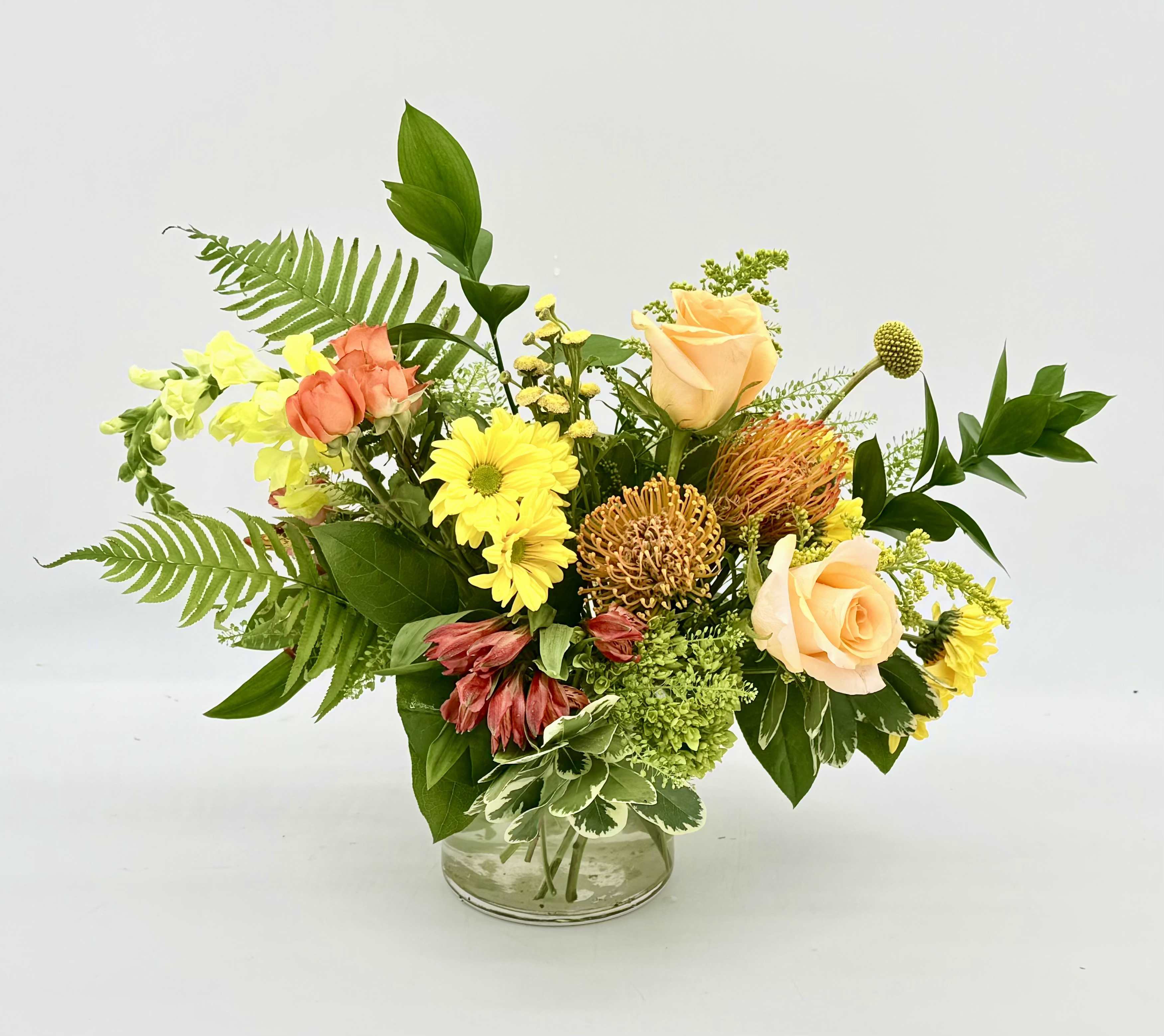 Citrus Zest - Citrus Zest is a bright, cheerful arrangement inspired by the fresh colors of citrus fruits. Featuring sunny yellow blooms, pops of vibrant orange texture, this design brings a refreshing burst of color to any occasion!