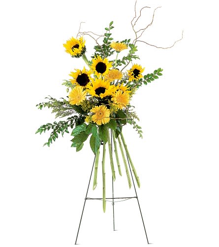 Tall sunflower arrangement on a stand with yellow blooms and greenery