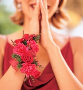 Woman wearing a pink floral wrist corsage