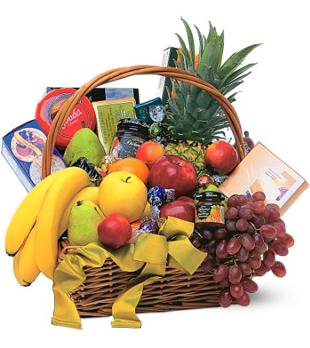 Fruit basket with bananas, apples, grapes, pineapple, and packaged snacks