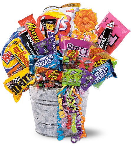 Bucket filled with assorted candy bags and a decorative flower topper