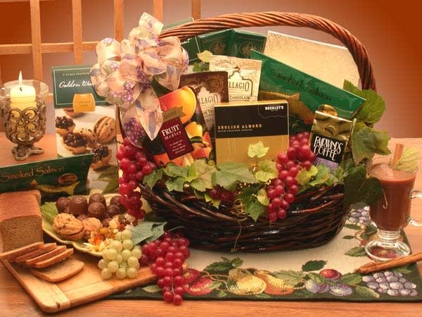 Gift basket with chocolates, snacks, and a candle