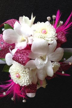 White orchids and daisies with bright pink accents on a black background