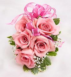 Pink rose bouquet with ribbon and small white filler flowers