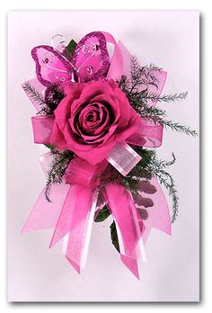 Pink rose corsage with butterfly decoration and ribbon