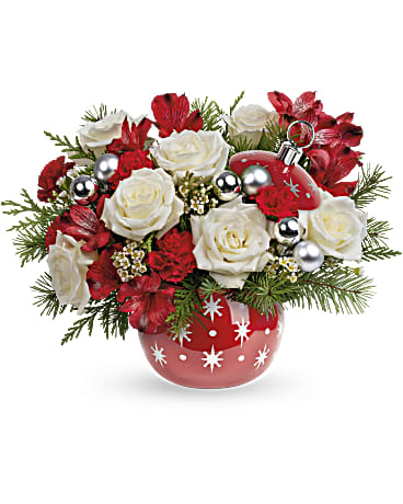 Red and white roses in a red ornamented vase