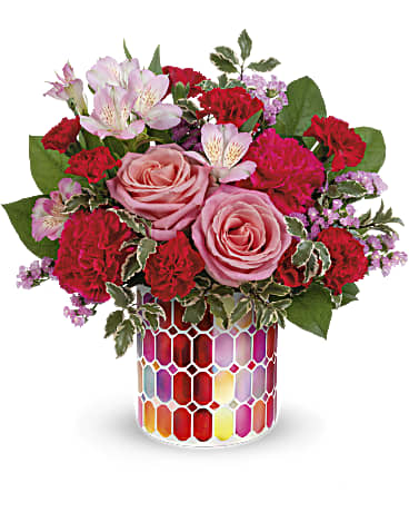 Teleflora's Charming Mosaic Bouquet - Inspired by antique stained glass windows, this charming mosaic vase is such a treat when filled with sweet pink roses! Pink roses, pink alstroemeria, hot pink carnations, miniature red carnations and pink sinuata statice are arranged with pitta negra and lemon leaf. Delivered in a Charming Mosaic Cylinder.