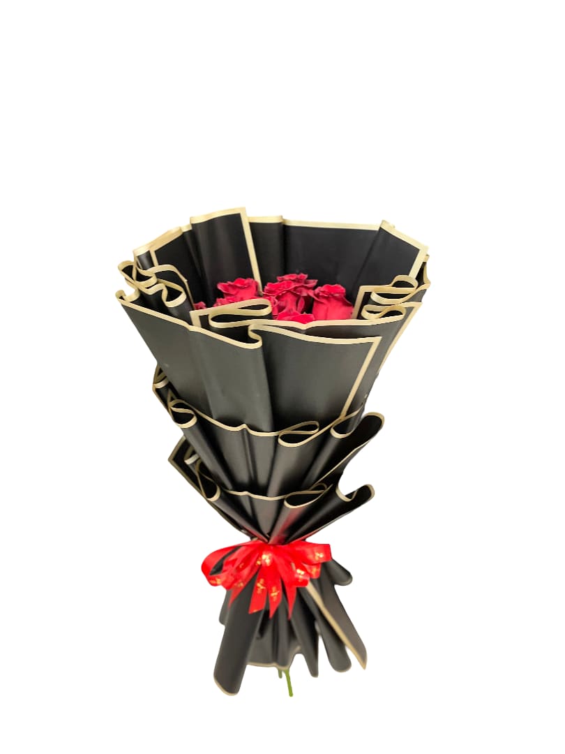 Bouquet of red roses wrapped in black paper with gold trim