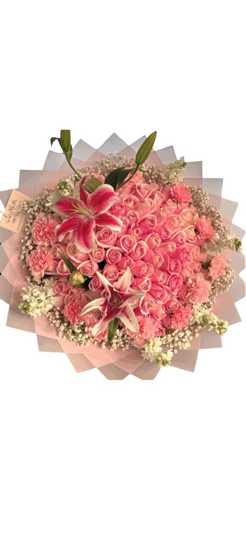 Pink rose bouquet with lilies and carnations wrapped in pastel paper
