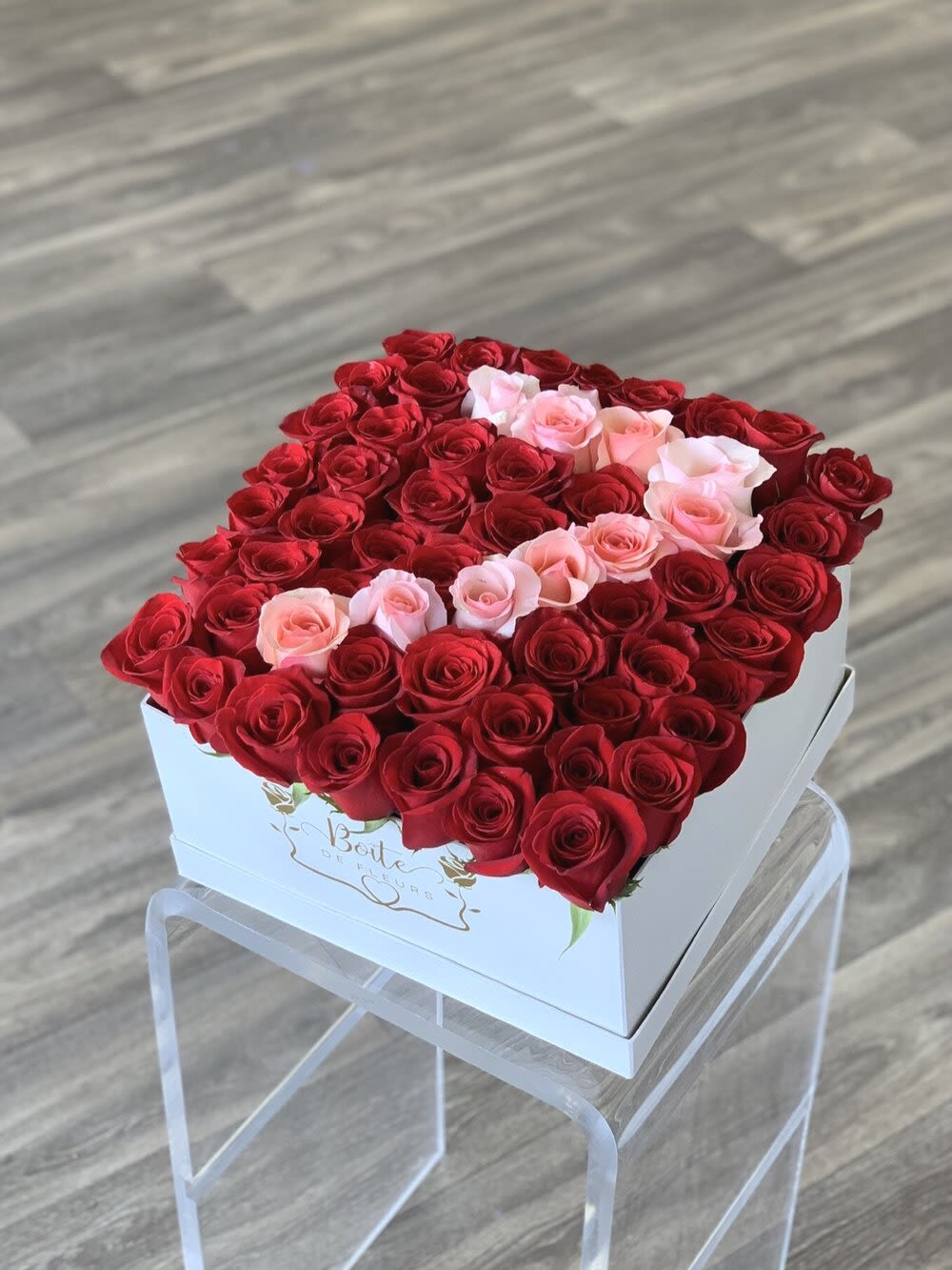 Heart-shaped box filled with red and pink roses