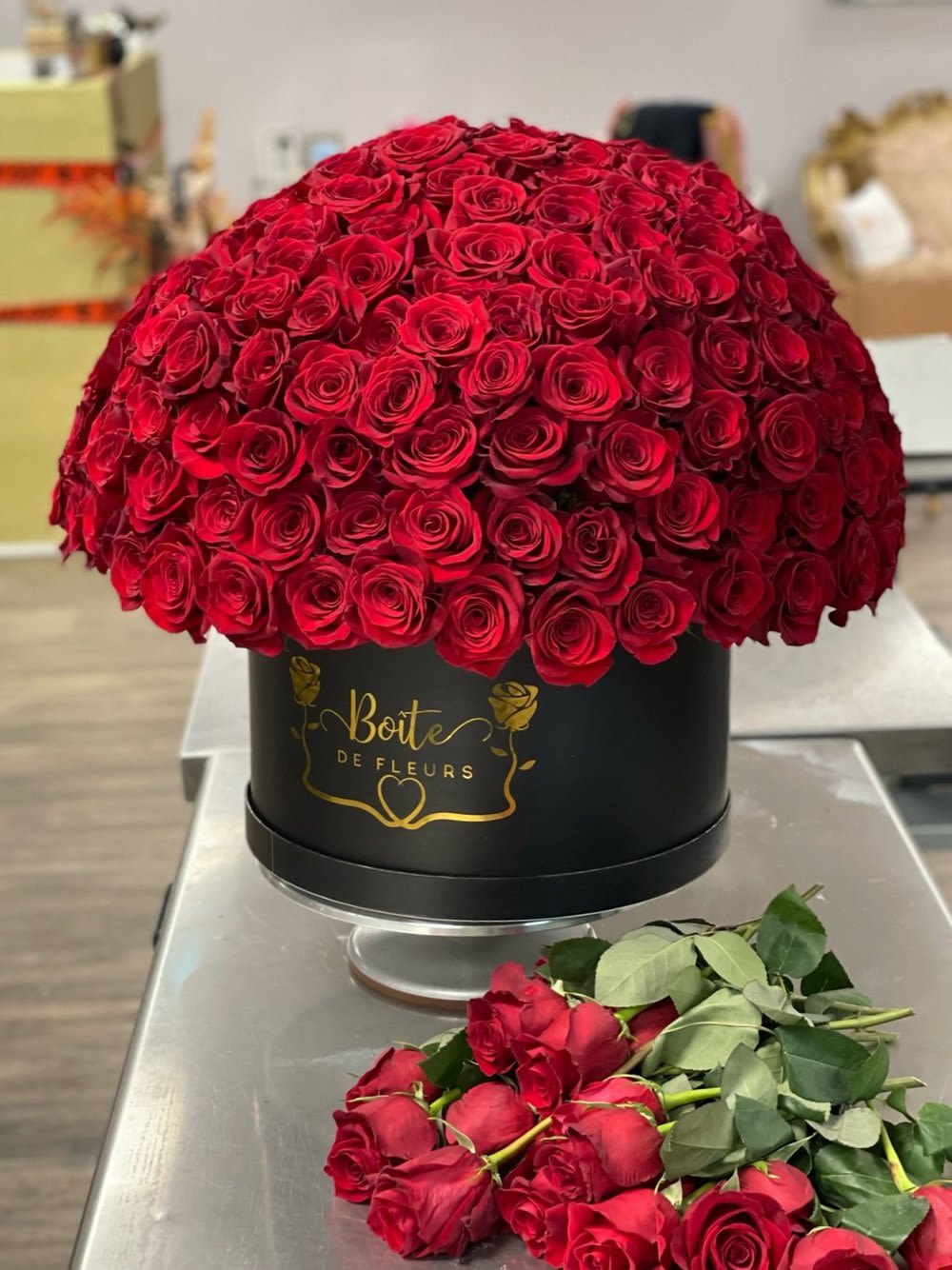 Large dome of red roses in a black round box