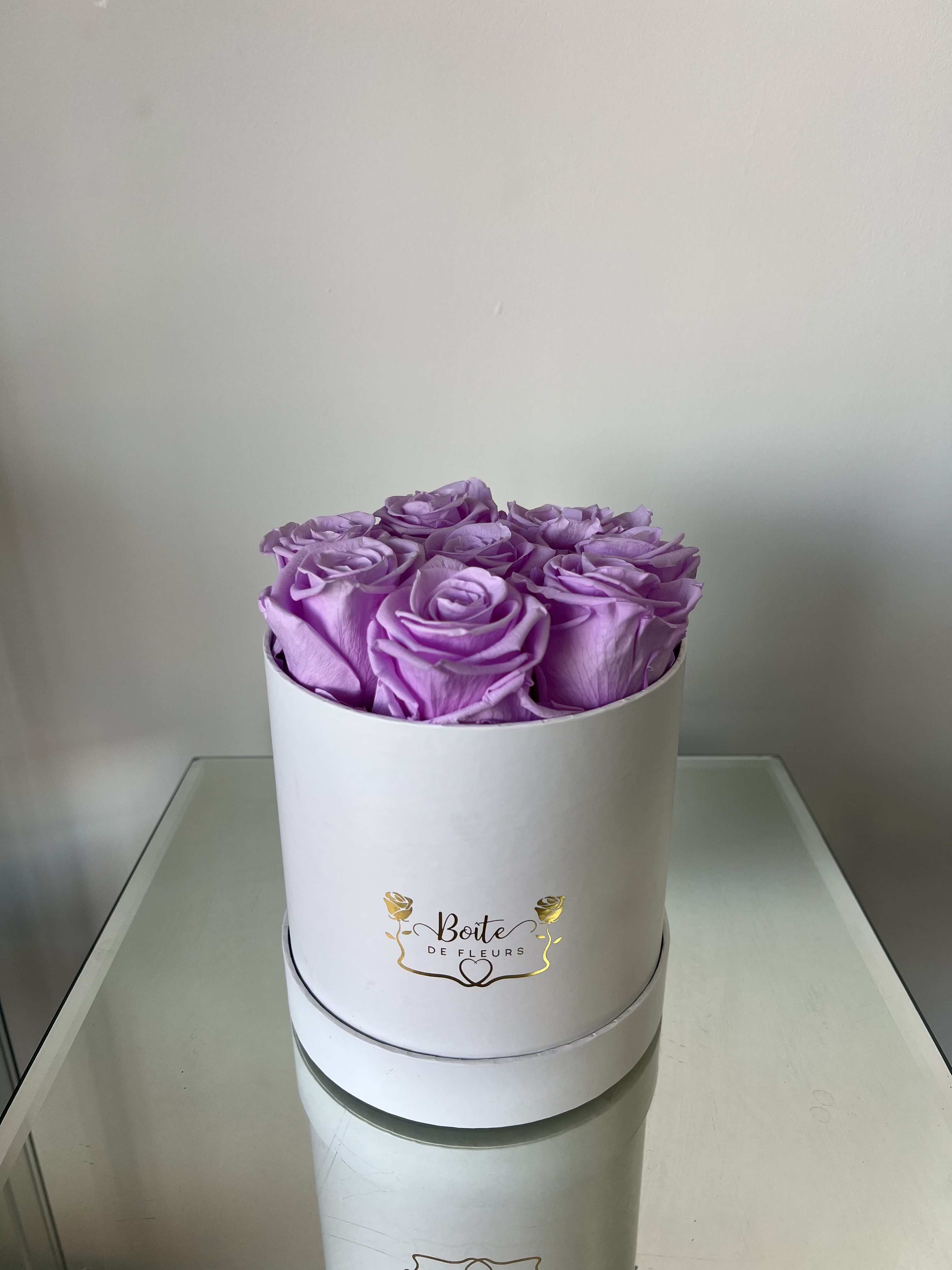 Forever Love (Lavender) - Make a bold and unforgettable statement with our Eternal Lavender Luxury Boîte, featuring premium long-lasting preserved lavender roses beautifully arranged in our signature white Boîte de Fleurs box. This arrangement is the perfect gift for anniversaries, Valentine’s Day, birthdays, proposals, or just because.  Each preserved rose is carefully selected and treated to maintain its natural beauty for months (even years) with proper care — no water required. These real roses maintain their soft texture and rich lavender color, offering a modern alternative to traditional fresh flower arrangements.  Boîte de Fleurs specializes in luxury boxed flower arrangements in Phoenix, Scottsdale, and Paradise Valley. We offer premium flower delivery throughout the Phoenix metro area with beautifully packaged, statement-making designs.  Limited quantities available. Order your preserved red rose arrangement today for local Phoenix flower delivery.