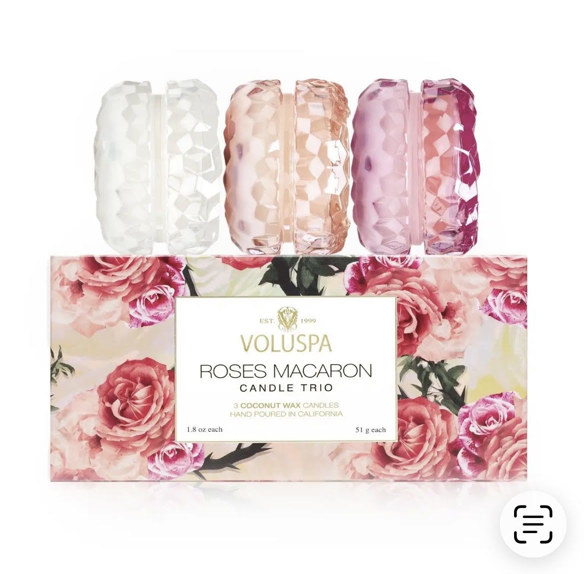 Three rose-scented candles in faceted glass holders with floral packaging